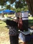 photo of boy holding a chicken at a kissing booth
